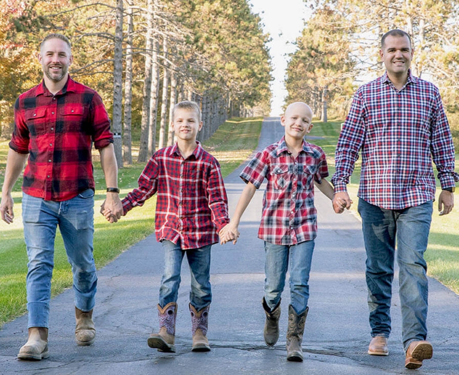 family sells mini highland cow holding hands